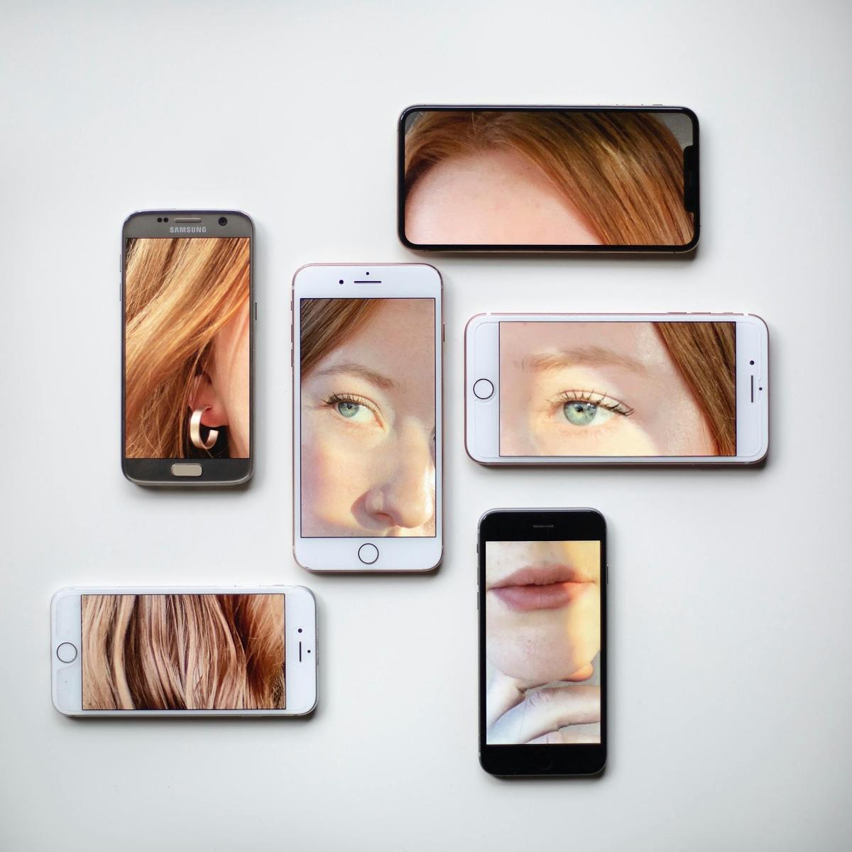 Phones of different sizes, each showing part of the same face